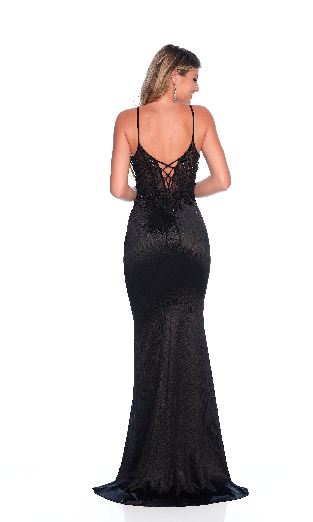 A woman models the Dave & Johnny 11791 long black prom dress, featuring a fitted satin skirt, thin straps, and a lace-up open back, against a white background.